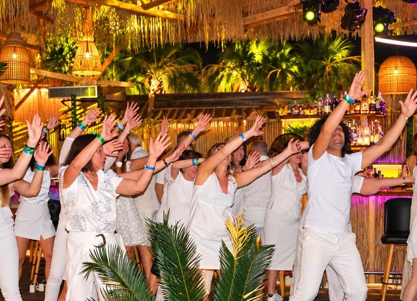 An all-white dance party under the lights